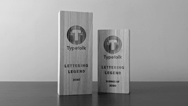 Two wooden Typefolk Lettering Legend award trophies